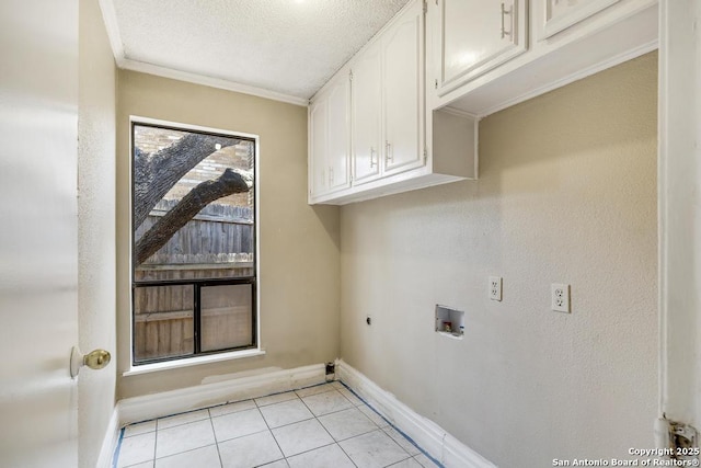 laundry room with cabinet space, electric dryer hookup, washer hookup, baseboards, and light tile patterned floors