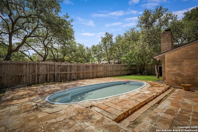 view of pool featuring a fenced backyard and a patio