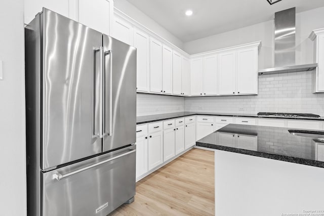 305 Lawrence Dr, Castroville, TX 78009 - kitchen featuring stainless steel appliances, wall chimney range hood, white cabinets, light wood-type flooring, and recessed lighting