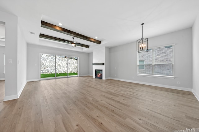 305 Lawrence Dr, Castroville, TX 78009 - unfurnished living room featuring light wood finished floors, healthy amount of natural light, a chandelier, a ceiling fan, and recessed lighting