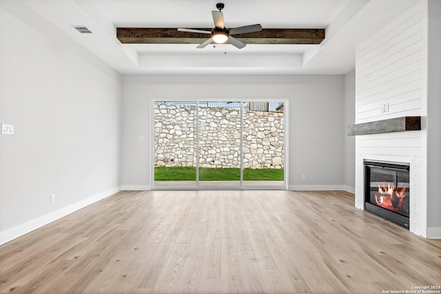 305 Lawrence Dr, Castroville, TX 78009 - unfurnished living room with a fireplace, wood finished floors, ceiling fan, beamed ceiling, and baseboards