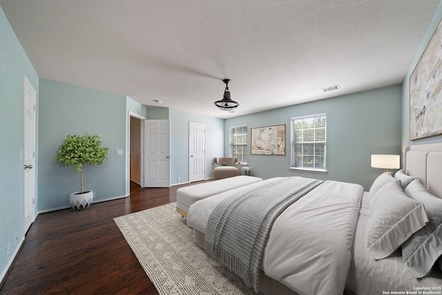 3738 Sumantra, San Antonio, TX 78261 - bedroom featuring dark wood-type flooring, a textured ceiling, and baseboards