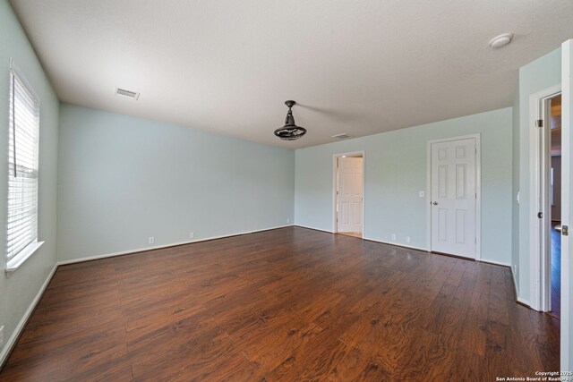 3738 Sumantra, San Antonio, TX 78261 - unfurnished room featuring dark wood finished floors, baseboards, and a smoke detector
