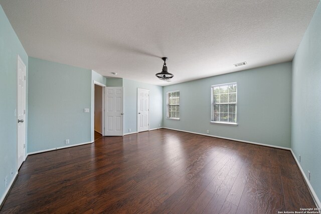 3738 Sumantra, San Antonio, TX 78261 - unfurnished room with dark wood-style flooring, baseboards, and a textured ceiling