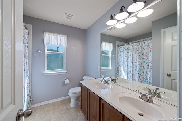 3738 Sumantra, San Antonio, TX 78261 - full bathroom featuring toilet, baseboards, double vanity, and tile patterned flooring