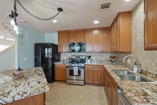 3738 Sumantra, San Antonio, TX 78261 - kitchen with black appliances, a sink, brown cabinetry, backsplash, and light stone counters