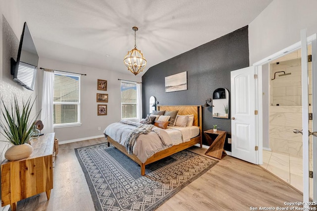 13410 Canyon Mdws, San Antonio, TX 78254 - bedroom with a chandelier, lofted ceiling, baseboards, wood finished floors, and connected bathroom