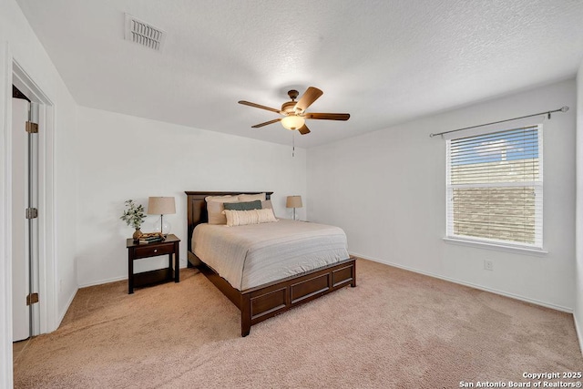 13410 Canyon Mdws, San Antonio, TX 78254 - bedroom with light carpet, baseboards, ceiling fan, and a textured ceiling