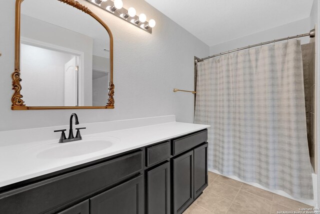 13410 Canyon Mdws, San Antonio, TX 78254 - bathroom with vanity, tile patterned floors, and curtained shower