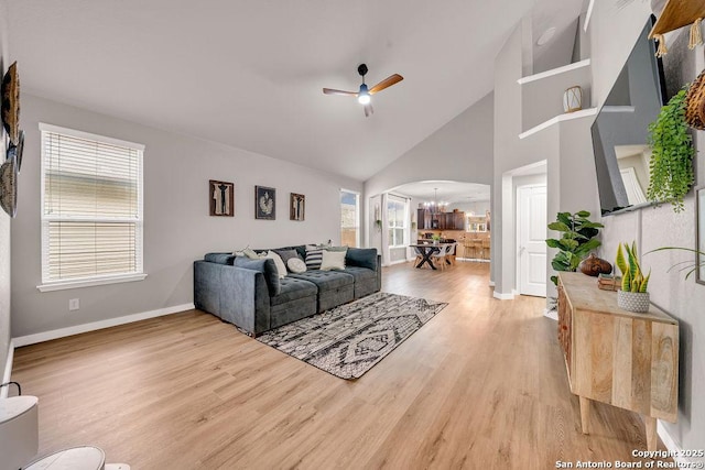 13410 Canyon Mdws, San Antonio, TX 78254 - living room featuring arched walkways, a ceiling fan, light wood-style floors, baseboards, and high vaulted ceiling