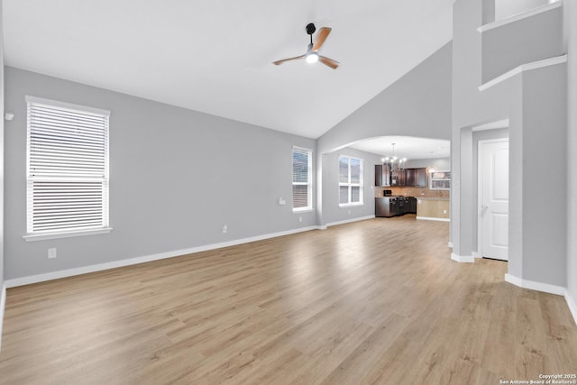 13410 Canyon Mdws, San Antonio, TX 78254 - unfurnished living room featuring a chandelier, ceiling fan, high vaulted ceiling, light wood finished floors, and baseboards