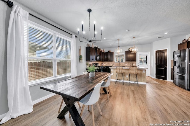 13410 Canyon Mdws, San Antonio, TX 78254 - dining space featuring a chandelier, light wood-type flooring, a textured ceiling, baseboards, and recessed lighting