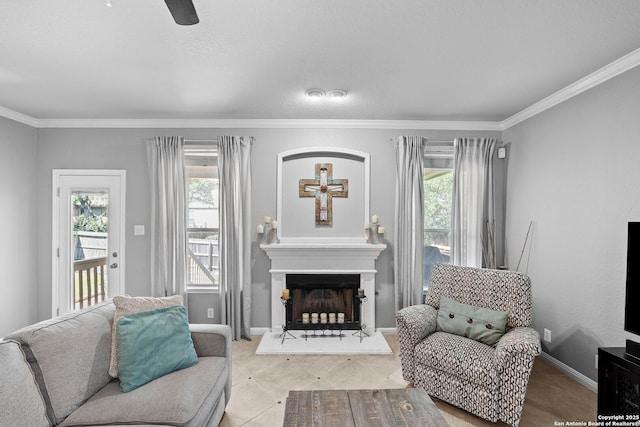 22841 San Saba Blf, San Antonio, TX 78258 - sitting room featuring ornamental molding, ceiling fan, baseboards, and a fireplace with raised hearth