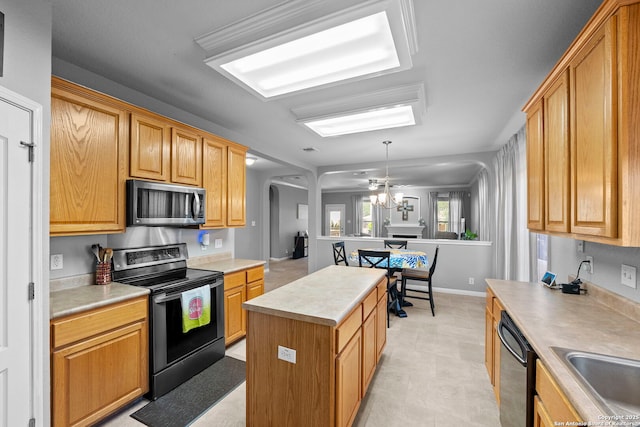22841 San Saba Blf, San Antonio, TX 78258 - kitchen with black appliances, light countertops, a kitchen island, a sink, and arched walkways