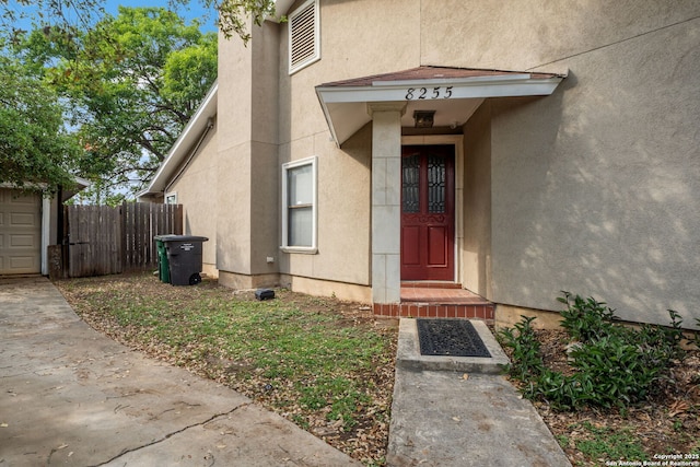 8255 Misty Willow, San Antonio, TX 78250 - doorway to property with stucco siding and fence