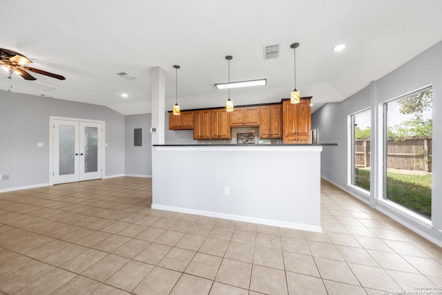 8255 Misty Willow, San Antonio, TX 78250 - kitchen featuring brown cabinetry, hanging light fixtures, a ceiling fan, light tile patterned flooring, and dark countertops