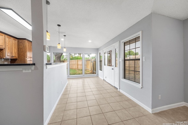8255 Misty Willow, San Antonio, TX 78250 - hall with a textured ceiling, plenty of natural light, light tile patterned floors, and baseboards