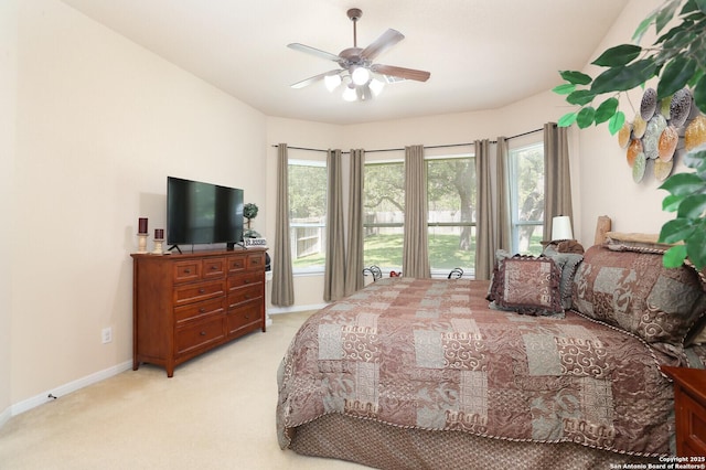 26940 Rustic Brk, San Antonio, TX 78261 - bedroom with light carpet, multiple windows, baseboards, and a ceiling fan