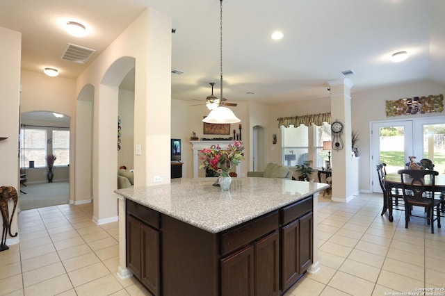 26940 Rustic Brk, San Antonio, TX 78261 - kitchen with arched walkways, light tile patterned floors, a ceiling fan, and plenty of natural light