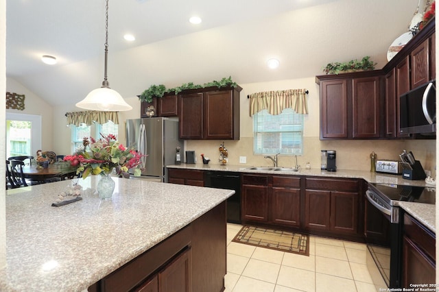 26940 Rustic Brk, San Antonio, TX 78261 - kitchen with stainless steel appliances, a sink, light tile patterned floors, lofted ceiling, and decorative light fixtures