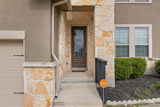 8515 Desert Cv, San Antonio, TX 78254 - doorway to property with stone siding, stucco siding, and a garage