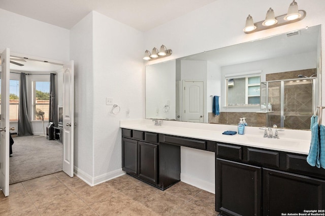 8515 Desert Cv, San Antonio, TX 78254 - full bath featuring double vanity, a stall shower, baseboards, and tile patterned floors