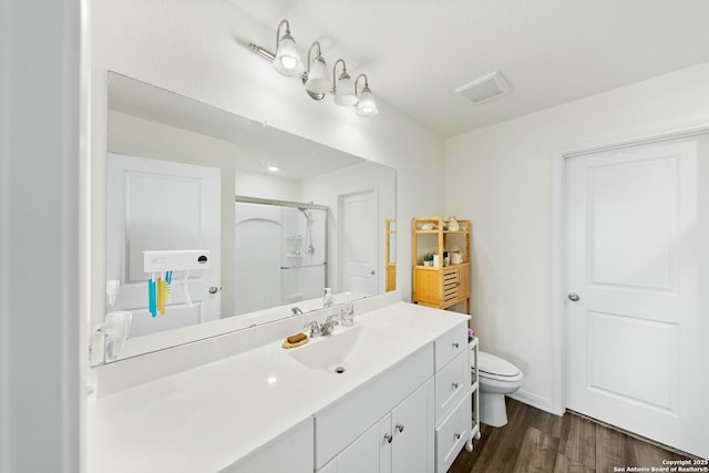 14407 Elkhorn Crst, San Antonio, TX 78253 - full bathroom featuring a stall shower, wood finished floors, toilet, and vanity