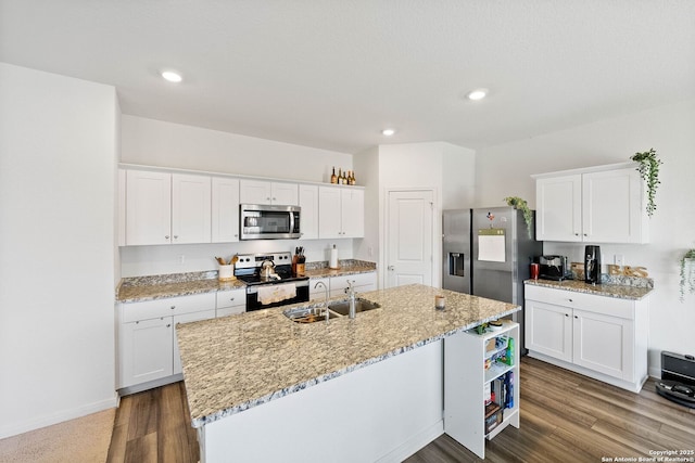 14407 Elkhorn Crst, San Antonio, TX 78253 - kitchen with appliances with stainless steel finishes, a sink, a center island with sink, white cabinetry, and dark wood finished floors