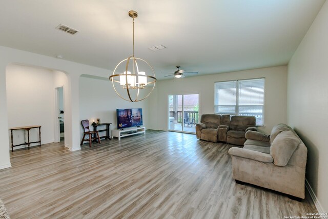 26323 Gibraltar, Boerne, TX 78015 - living room featuring wood finished floors, a ceiling fan, arched walkways, a chandelier, and baseboards