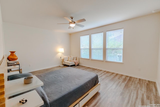26323 Gibraltar, Boerne, TX 78015 - bedroom featuring light wood-type flooring, baseboards, and a ceiling fan