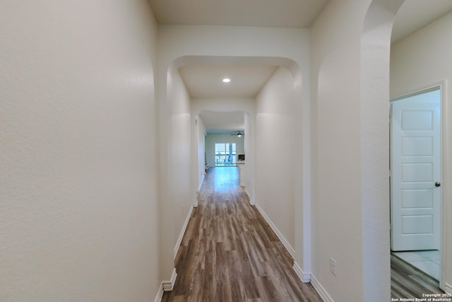 26323 Gibraltar, Boerne, TX 78015 - hall featuring wood finished floors, arched walkways, baseboards, and recessed lighting