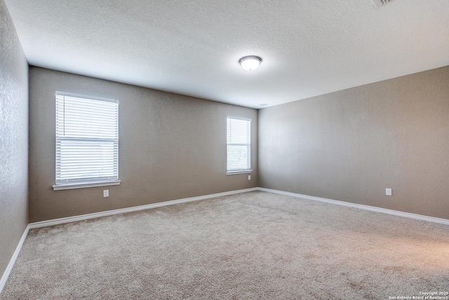 14802 Achilles Dr, San Antonio, TX 78245 - spare room featuring carpet floors, baseboards, and a textured ceiling