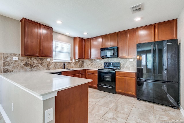 14802 Achilles Dr, San Antonio, TX 78245 - kitchen featuring black appliances, a sink, decorative backsplash, a peninsula, and light countertops