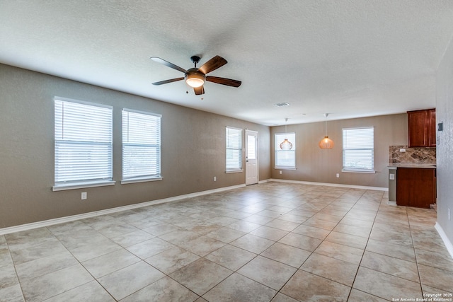 14802 Achilles Dr, San Antonio, TX 78245 - unfurnished living room with a ceiling fan, light tile patterned floors, a textured ceiling, and baseboards
