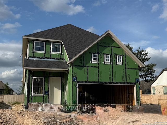property under construction with roof with shingles and fence