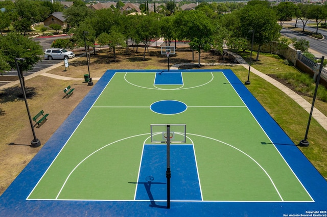 view of basketball court with community basketball court and fence