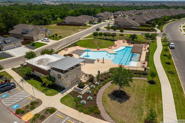 aerial perspective of suburban area featuring a pool