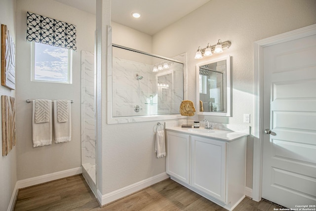 178 Jax Loop, San Antonio, TX 78253 - full bath with a marble finish shower, wood finished floors, vanity, and baseboards
