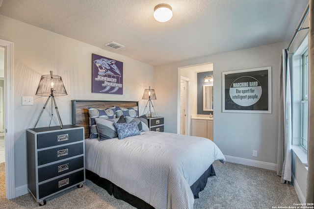 178 Jax Loop, San Antonio, TX 78253 - bedroom featuring carpet, a textured ceiling, baseboards, ensuite bath, and multiple windows