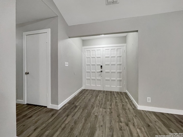 entryway with baseboards and wood finished floors