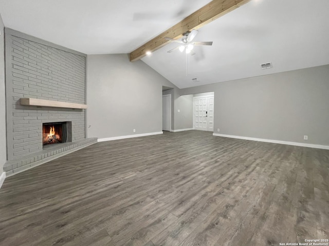 unfurnished living room with a ceiling fan, dark wood-style floors, a fireplace, and baseboards