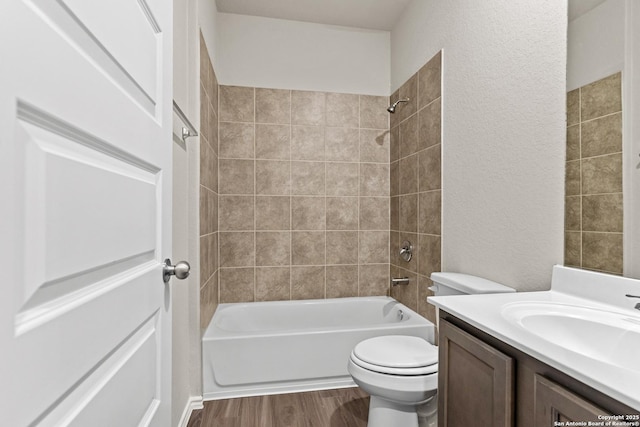 9318 Graze Br, San Antonio, TX 78211 - bathroom featuring wood finished floors, tub / shower combination, a textured wall, toilet, and vanity