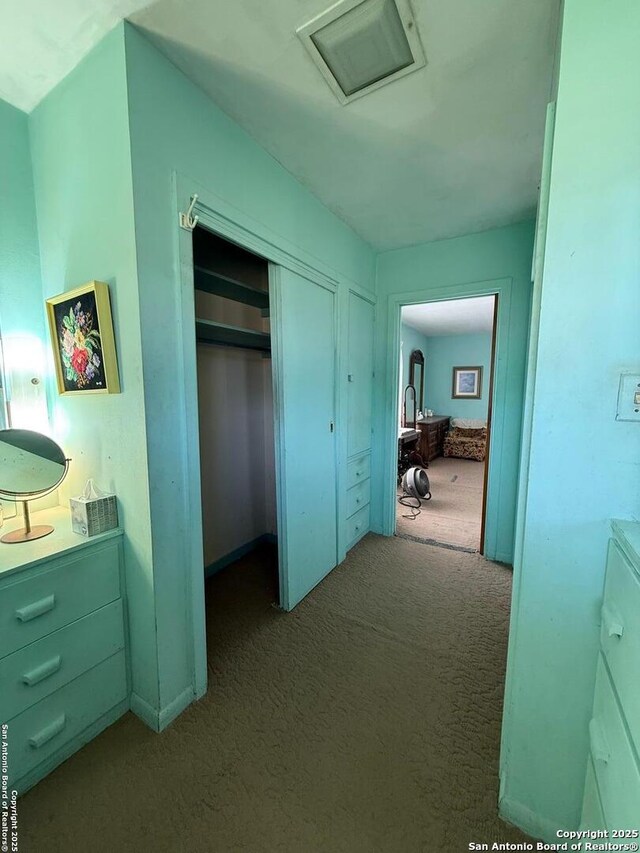 hall with carpet and attic access