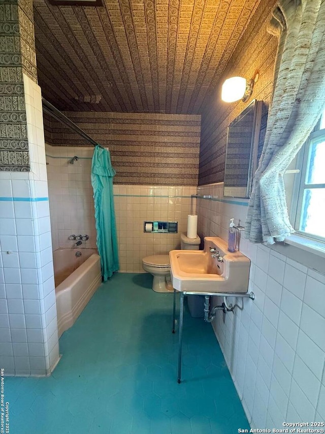 full bathroom featuring tile walls, toilet, shower / tub combo, a sink, and wooden ceiling