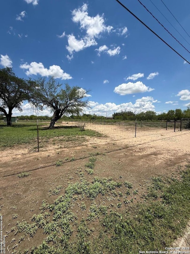 view of yard with a rural view and fence
