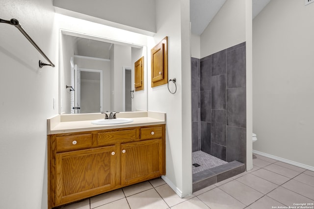 11819 Rousseau, San Antonio, TX 78251 - bathroom with tiled shower, tile patterned flooring, vanity, and baseboards