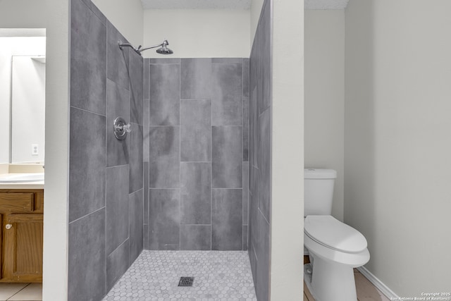 11819 Rousseau, San Antonio, TX 78251 - full bathroom featuring toilet, tiled shower, vanity, and tile patterned floors