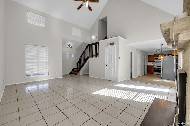 11819 Rousseau, San Antonio, TX 78251 - unfurnished living room featuring light tile patterned flooring, a ceiling fan, stairs, high vaulted ceiling, and baseboards