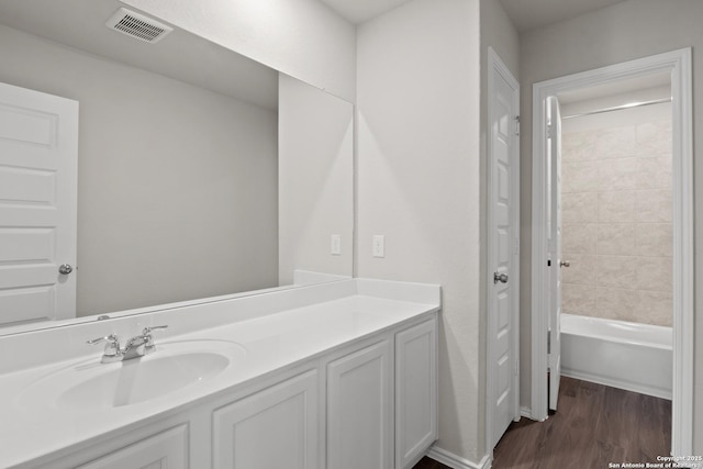 9410 Graze Land, San Antonio, TX 78211 - bathroom featuring vanity, wood finished floors, and shower / tub combination