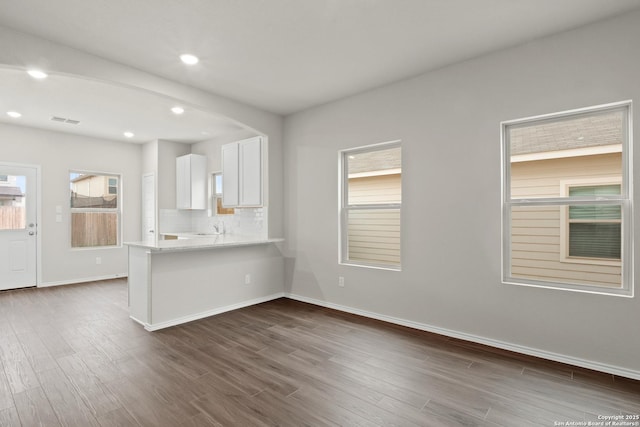 9410 Graze Land, San Antonio, TX 78211 - kitchen featuring white cabinets, dark wood finished floors, baseboards, healthy amount of natural light, and recessed lighting